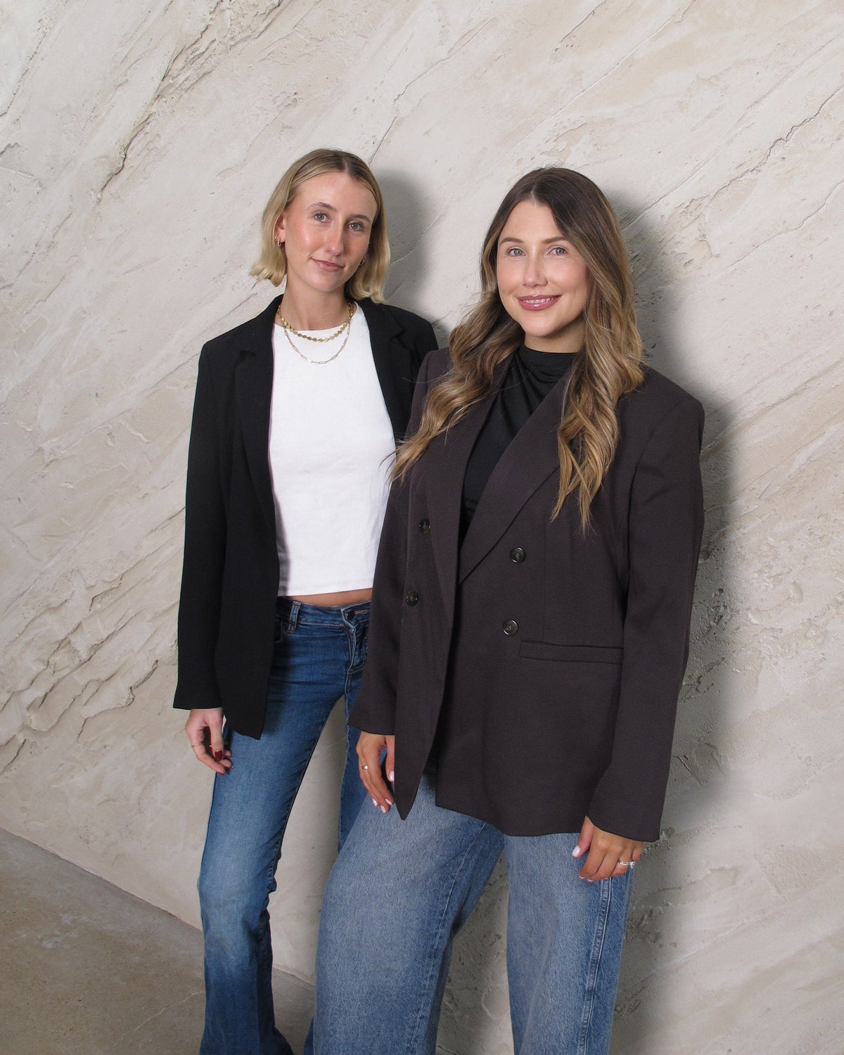 Annie and Kate standing together against the plaster wall at Sœur.