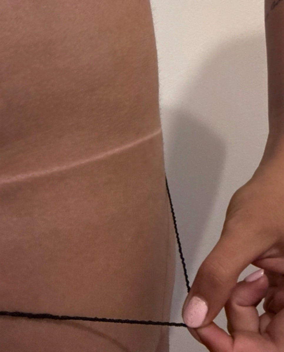 A close-up of a spray tan, the tan line showing against untanned skin