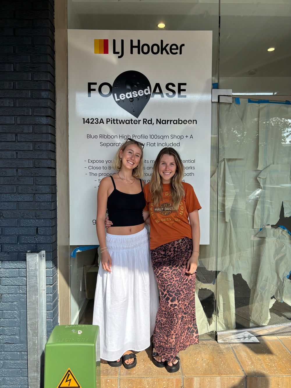 Annie and Kate outside the shop at 1423A Pittwater Road, Narrabeen, in front of the Leased sign